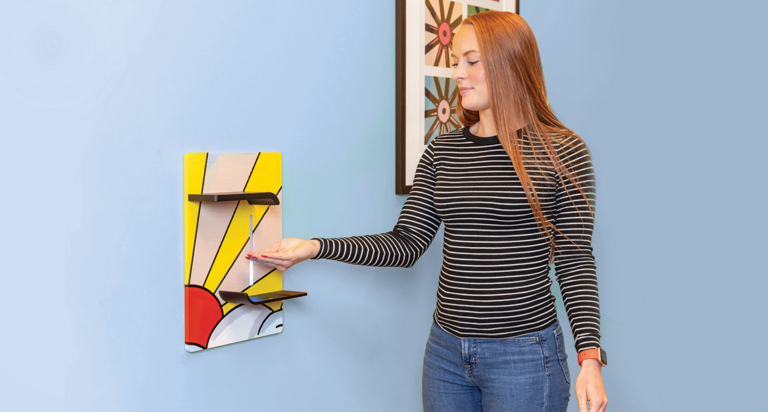 Woman using Vaask hand sanitizing fixture